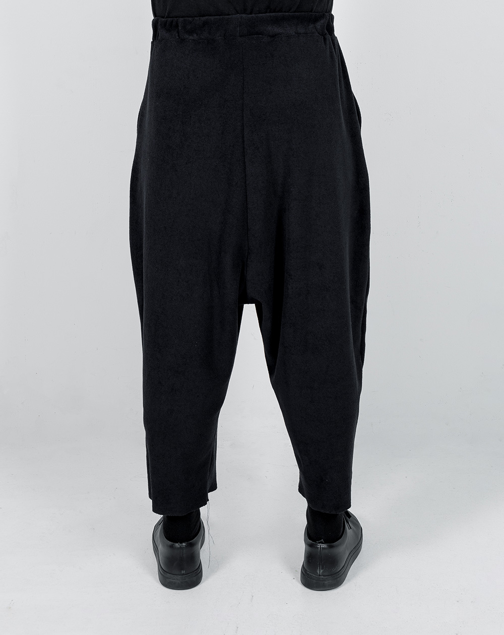 backside of ANTS. SAKE oversized sweatpants in black teddy fabric