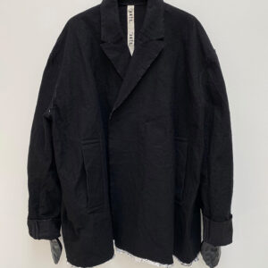 Frontside of oversized double breasted jacket in bonded wool and aluminium fabric