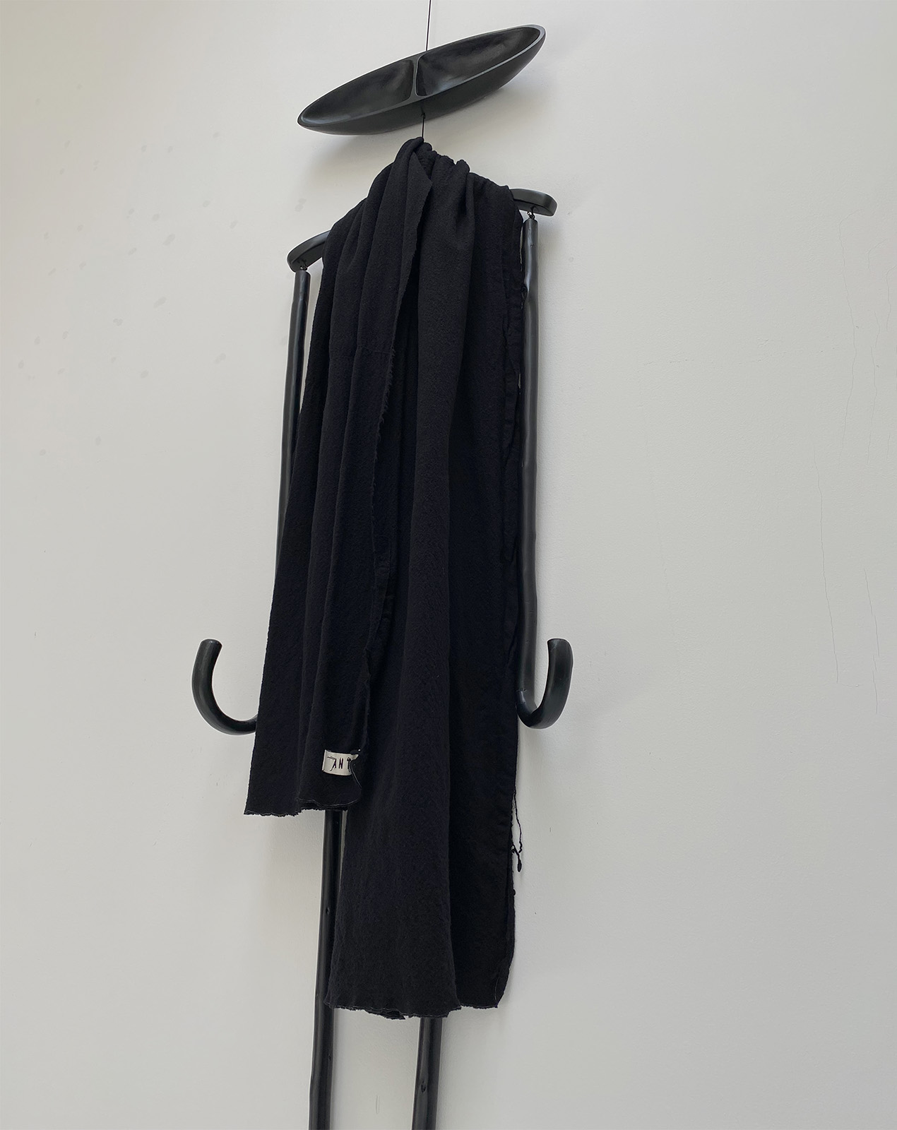 WEI WEI scarf in black boiled wool fabric displayed on doll