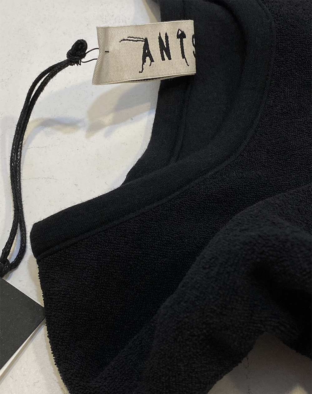 close up of neckline ANTS. SAKE sweatshirt in black teddy velours fabric