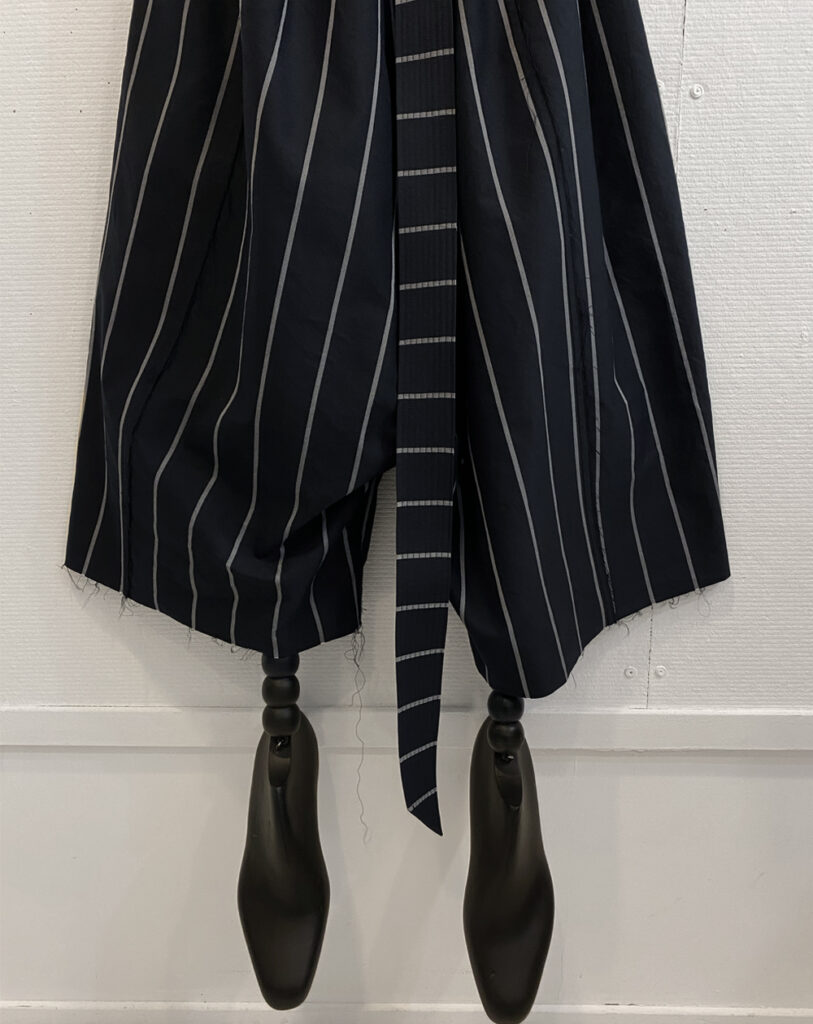 Cropped image of the legs of oversized striped pants