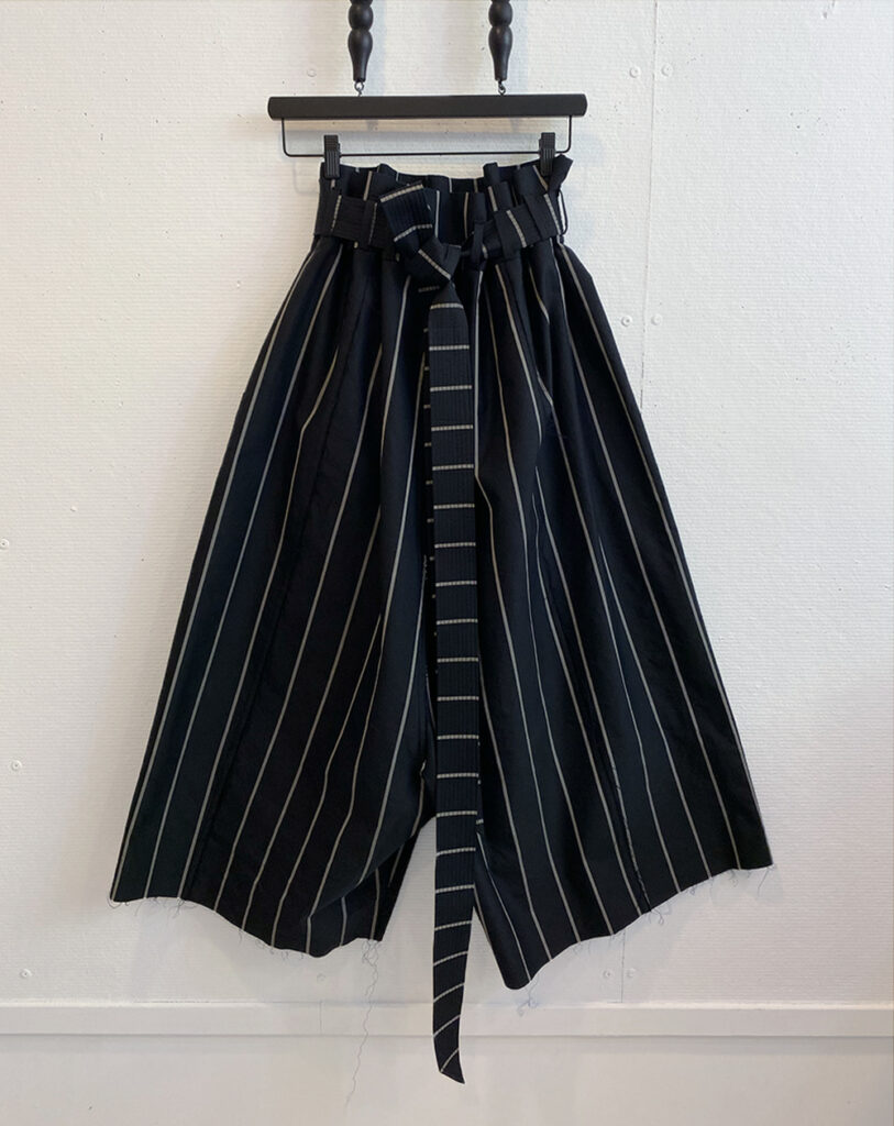 Image of frontside of oversized striped pants with paper bag waist