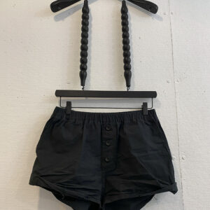 Washed cotton black shorts with fake button closure and raw edge hem and elastic waistband