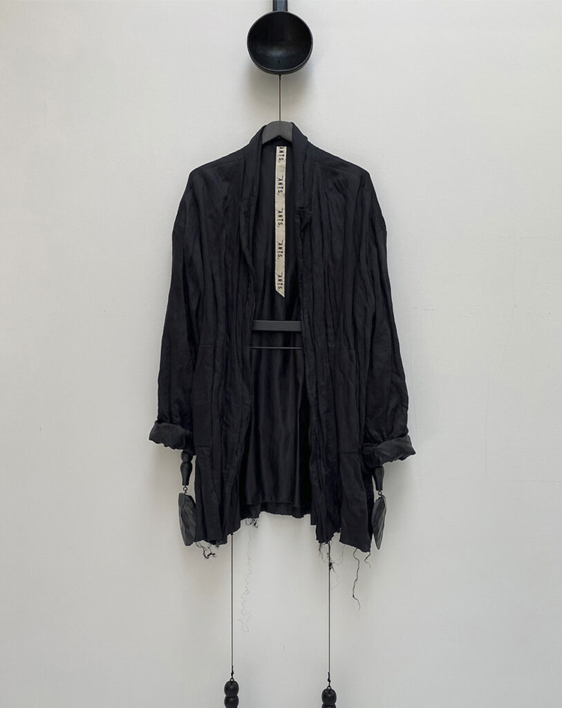 oversized black blazer in creased, crunchy viscose fabric