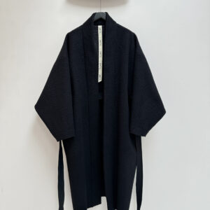 Frontside oversized pilled black wool coat in kimono style with padded and topstitched long belt