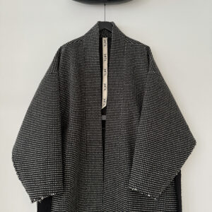 Close up of frontside of oversized kimono style wool coat with extra long belt