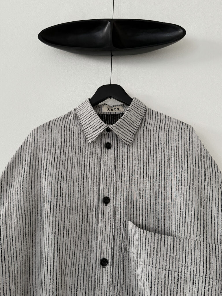 Close up of collar of oversized farmer's shirt in organic cotton jacquard light stripe