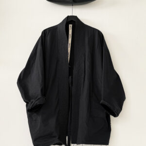 Frontside of oversized judo jacket in black washed organic cotton poplin