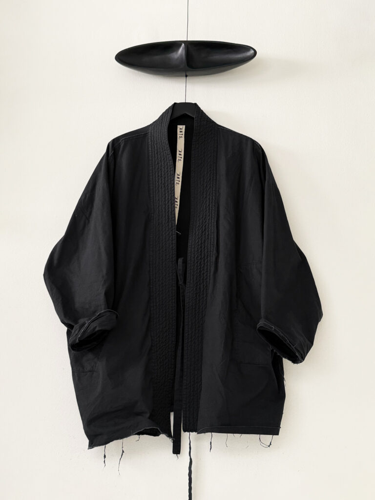 Frontside of oversized judo jacket in black washed organic cotton poplin